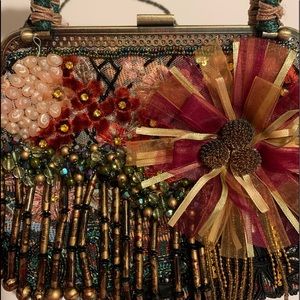 Chico’s beaded purse with handles and over shoulder chain. Great condition.